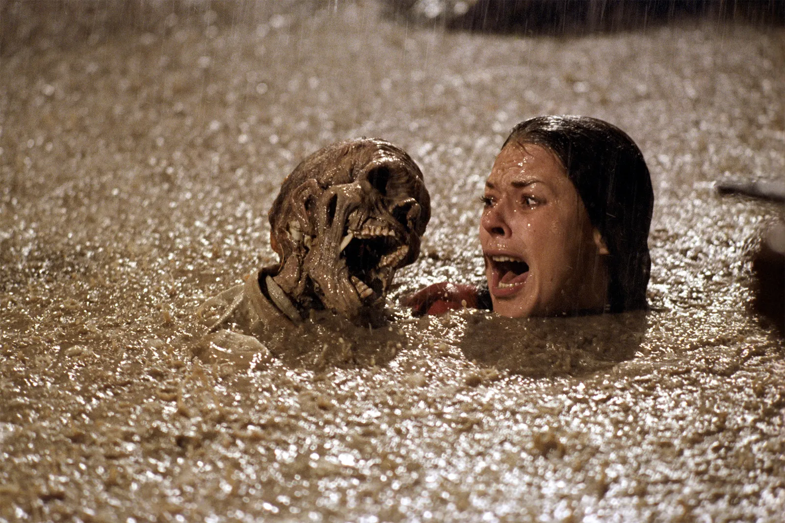JoBeth Williams screams face-to-face with a skull in a swimming pool in Poltergeist