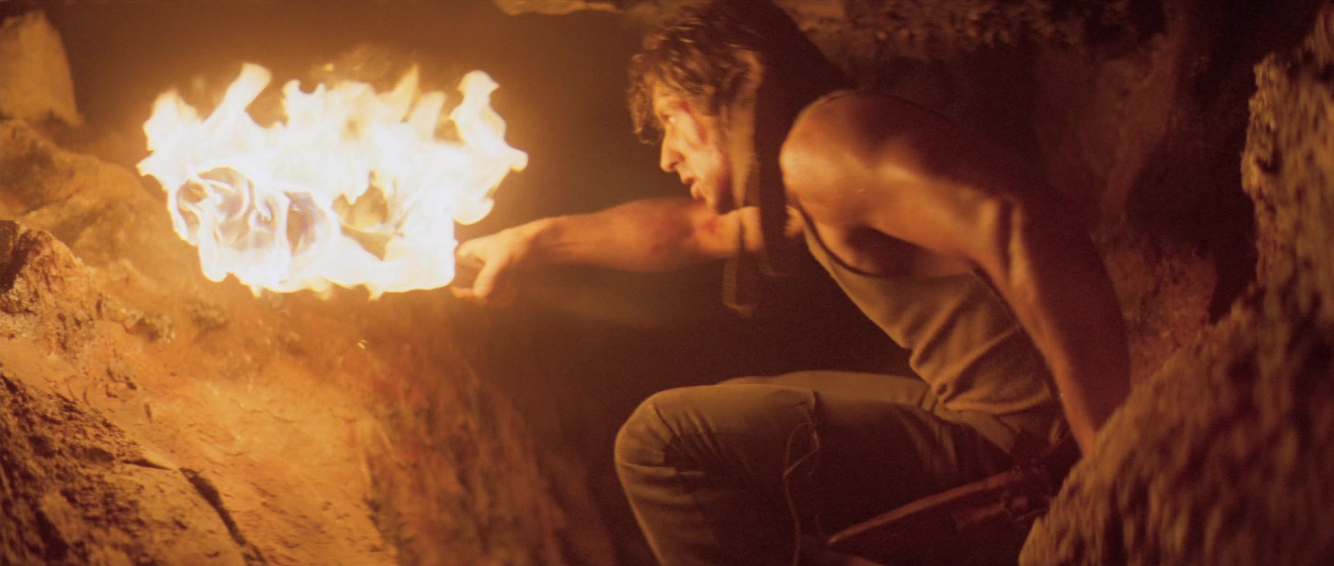Rambo lights a fire in an old mine
