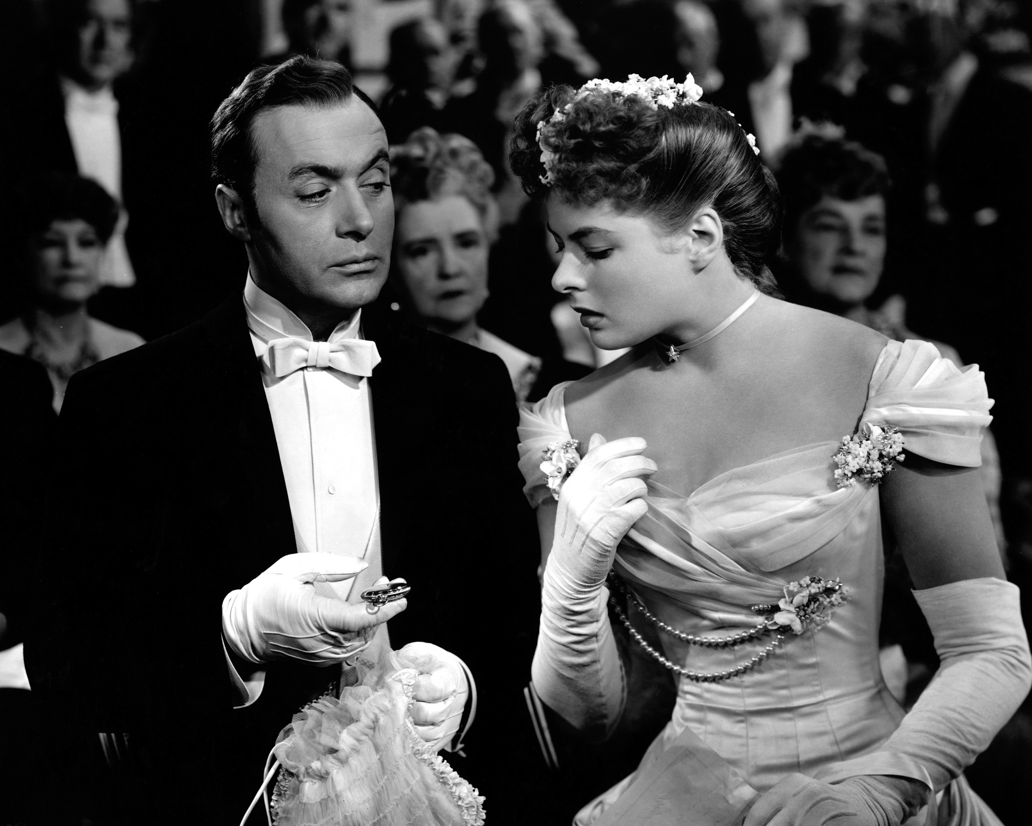 Charles Boyer shows Ingrid Bergman a watch