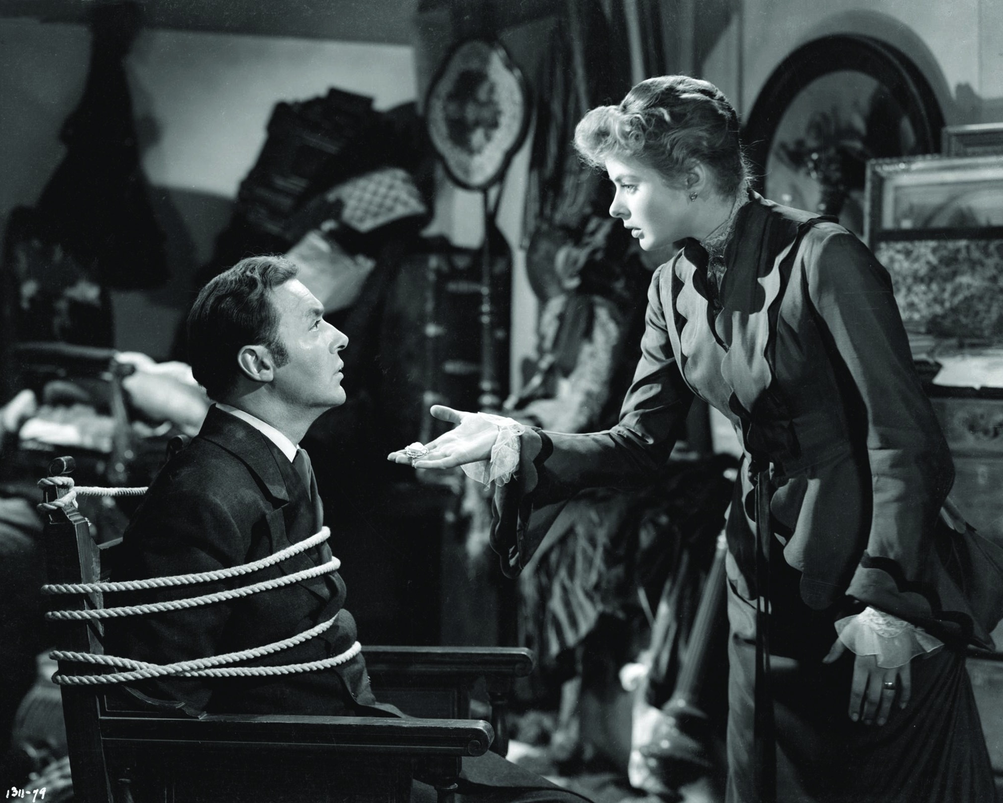 Ingrid Bergman confronts Charles Boyer, tied up in a chair