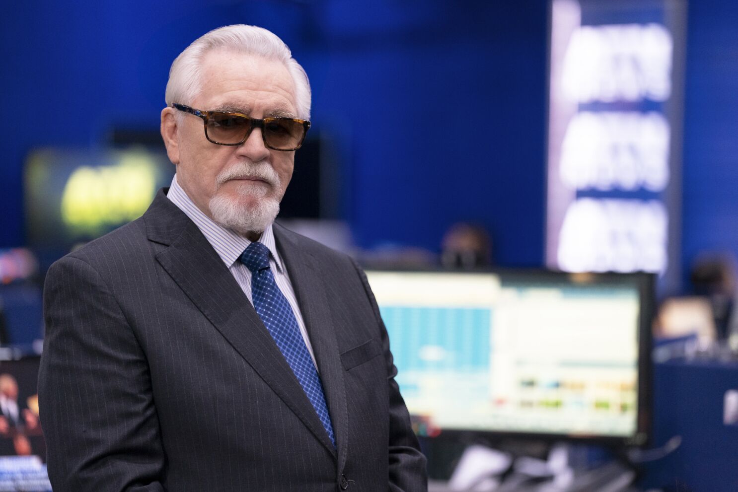 Brian Cox as Logan Roy, wearing sunglasses in the offices of ATN