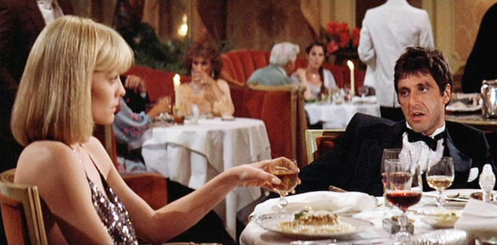 Elvira and Tony eating at a table in a fancy dinner club