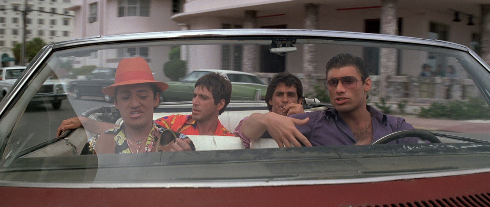 Al Pacino in the back seat of a convertible with 3 others in the car