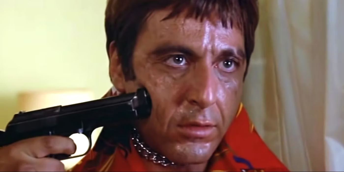 A perspiring Pacino with a gun pushing into his cheek