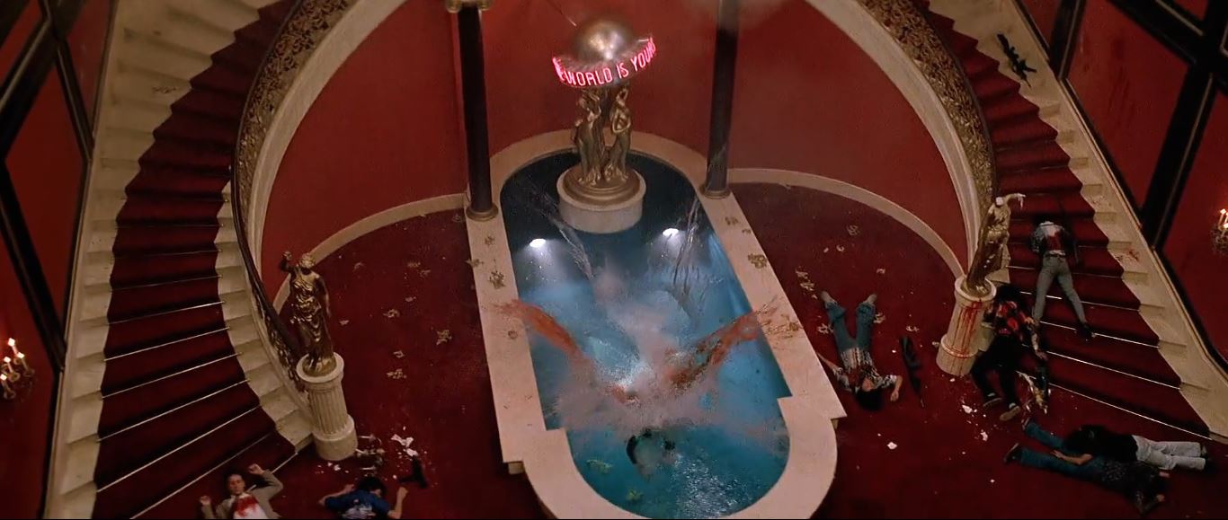 Tony's body splashes into the gaudy indoor pool
