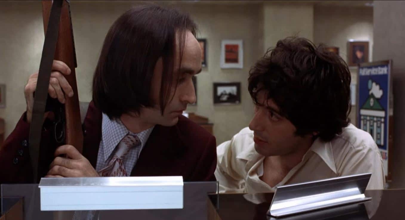 Sonny and Sal talk in the bank office