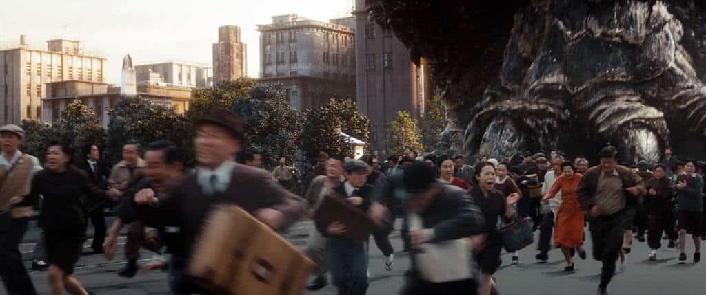 Godzilla's huge foot stomping on pedestrians in the streets