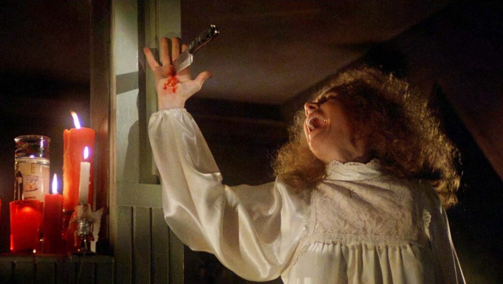 Carrie's mother screaming as a knife pierces her palm against the wall