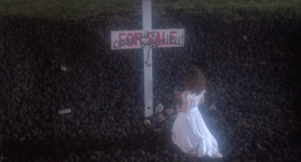 Sue Snell lays flowers on Carrie's grave