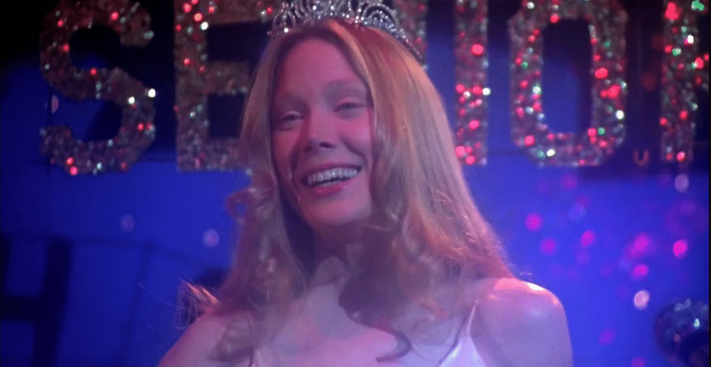Carrie smiles, wearing her sparkling crown