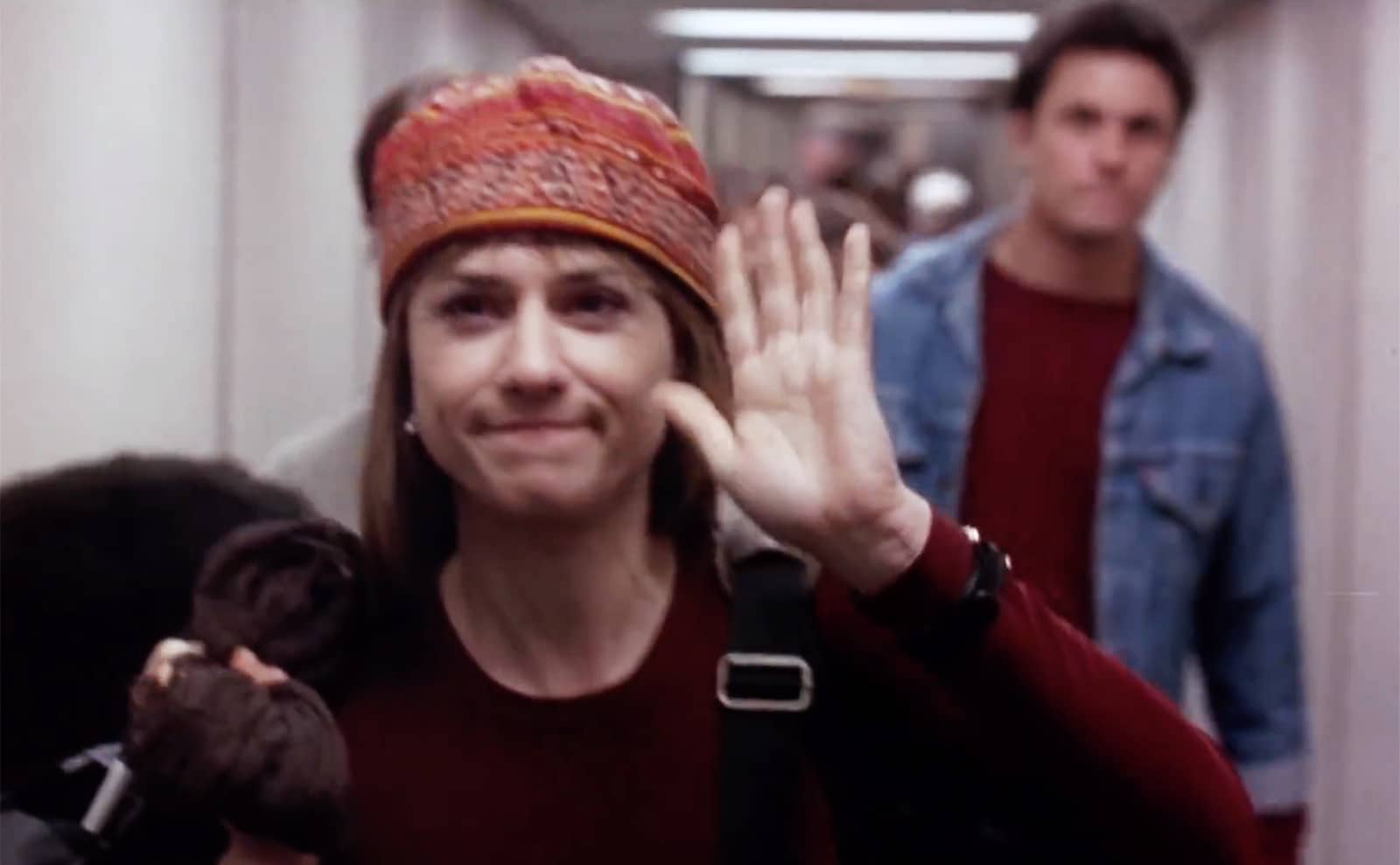 Claudia waves as she gets off the plane