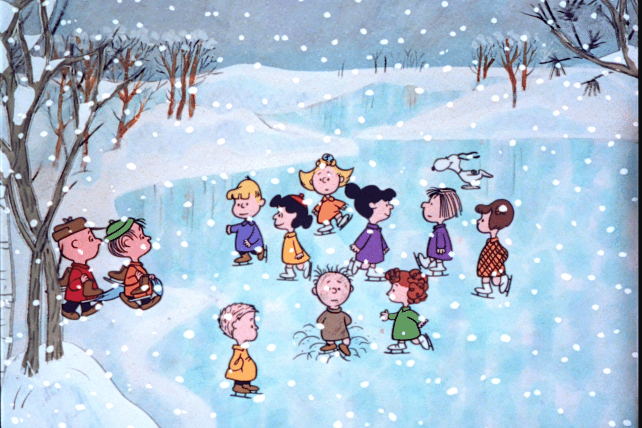The Peanuts characters skating n a frozen pond with snow falling