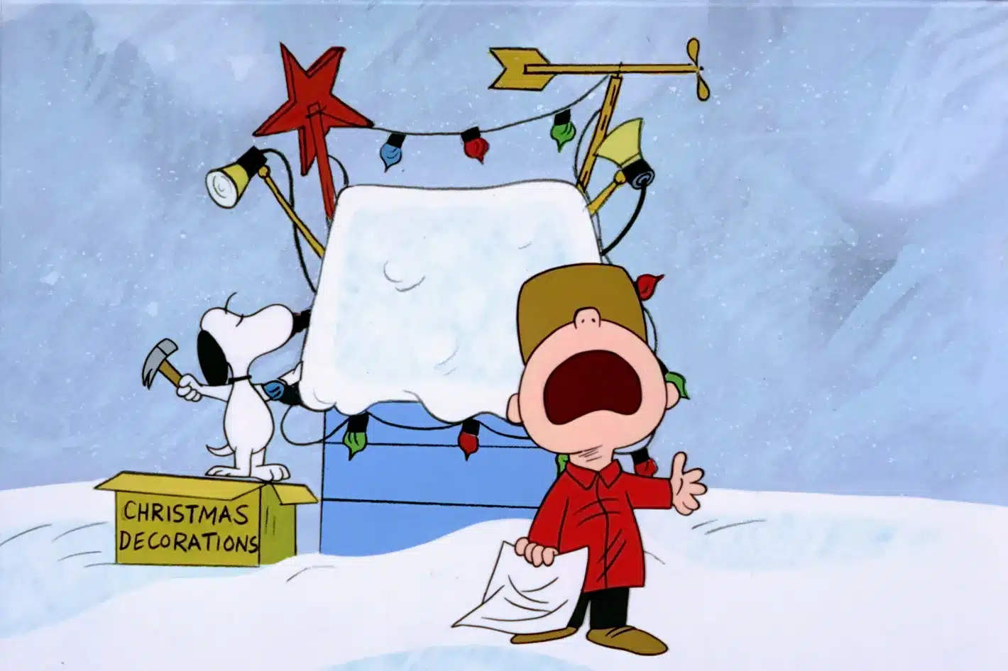 Charlie Brown frowns as Snoopy decorates his dog house with Christmas lights