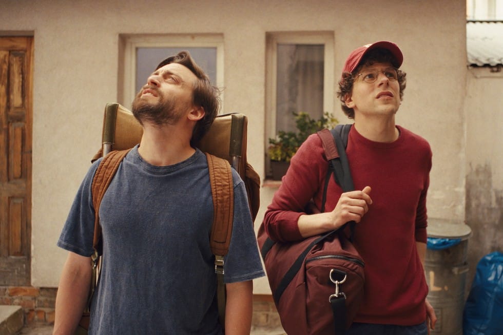 Benji and David, standing in the street with backpacks