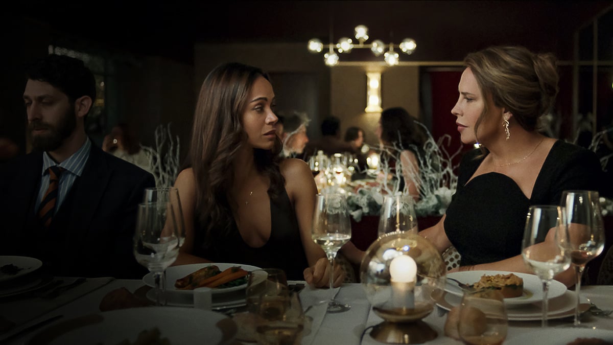 Rita sits next to Emilia at a fancy dinner table