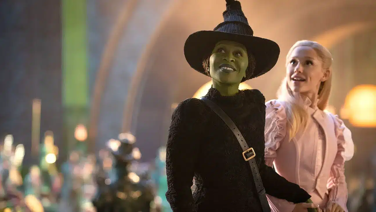 Elphaba in her hat and holding Galinda's hand