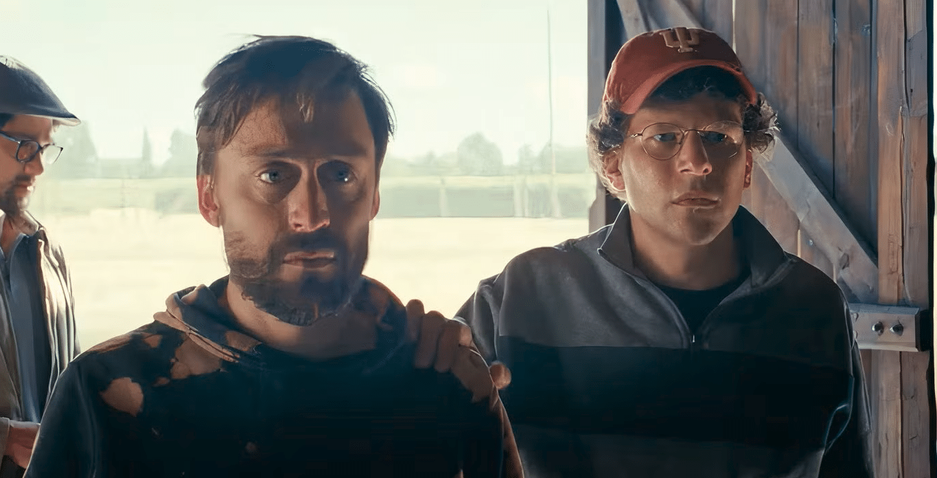 Kieran Culkin and Jesse Eisenberg enter a building in the Majdanek concentration camp