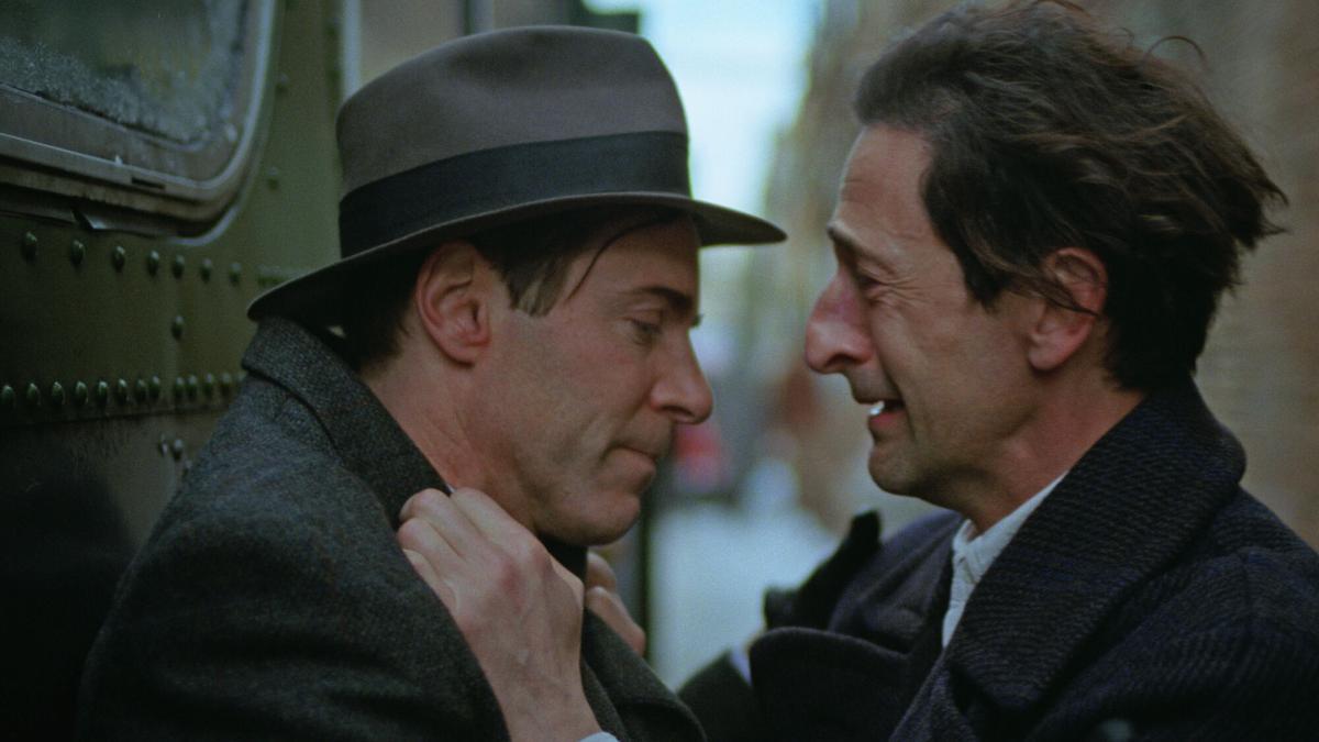 Attila and Lazlo hug by the bus.