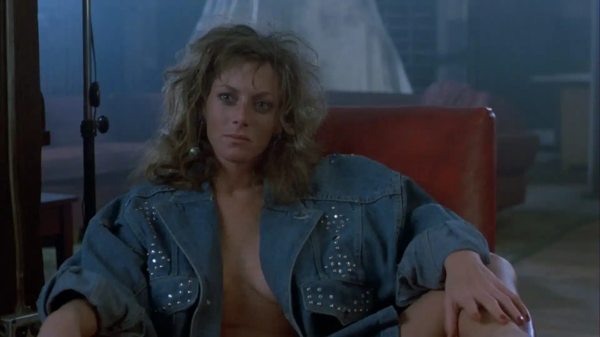 Joy Boushel wearing an open denim jacket top in The Fly