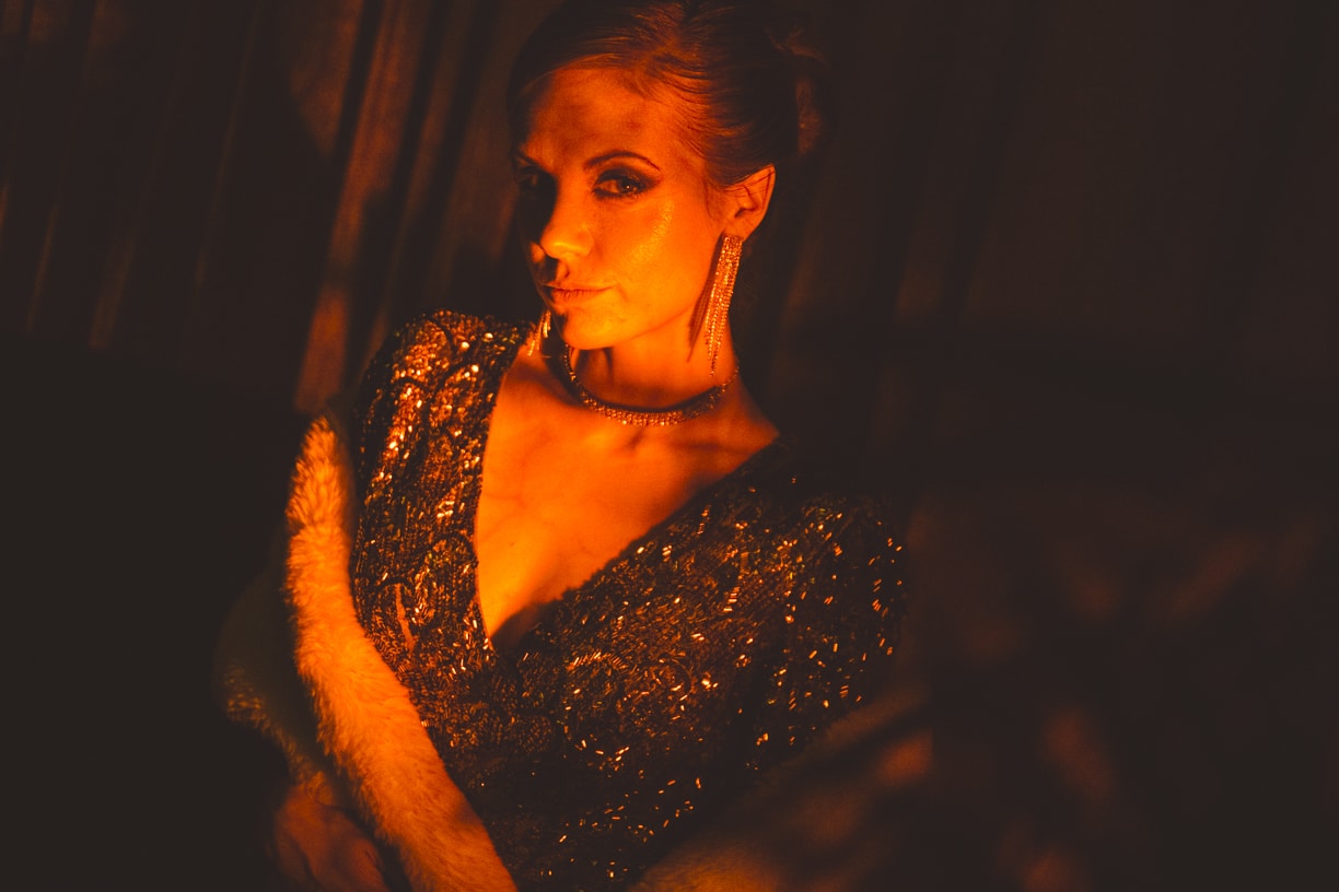 An elegantly dressed woman in a low-cut gown in a Ghost Ship Mystery