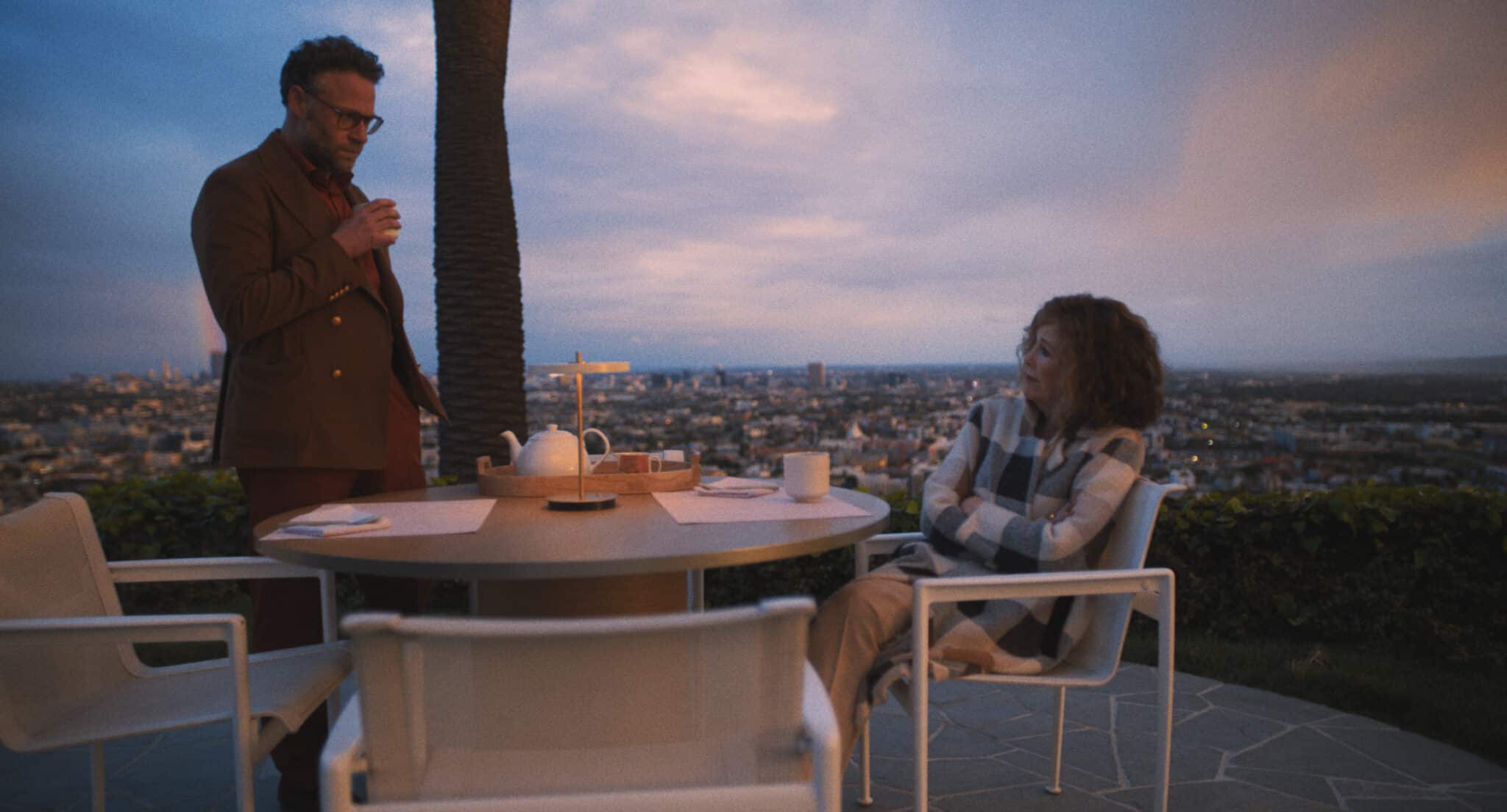 On a patio overlooking Los Angeles, Matt Remick stands and drinks with seated Patty Leigh