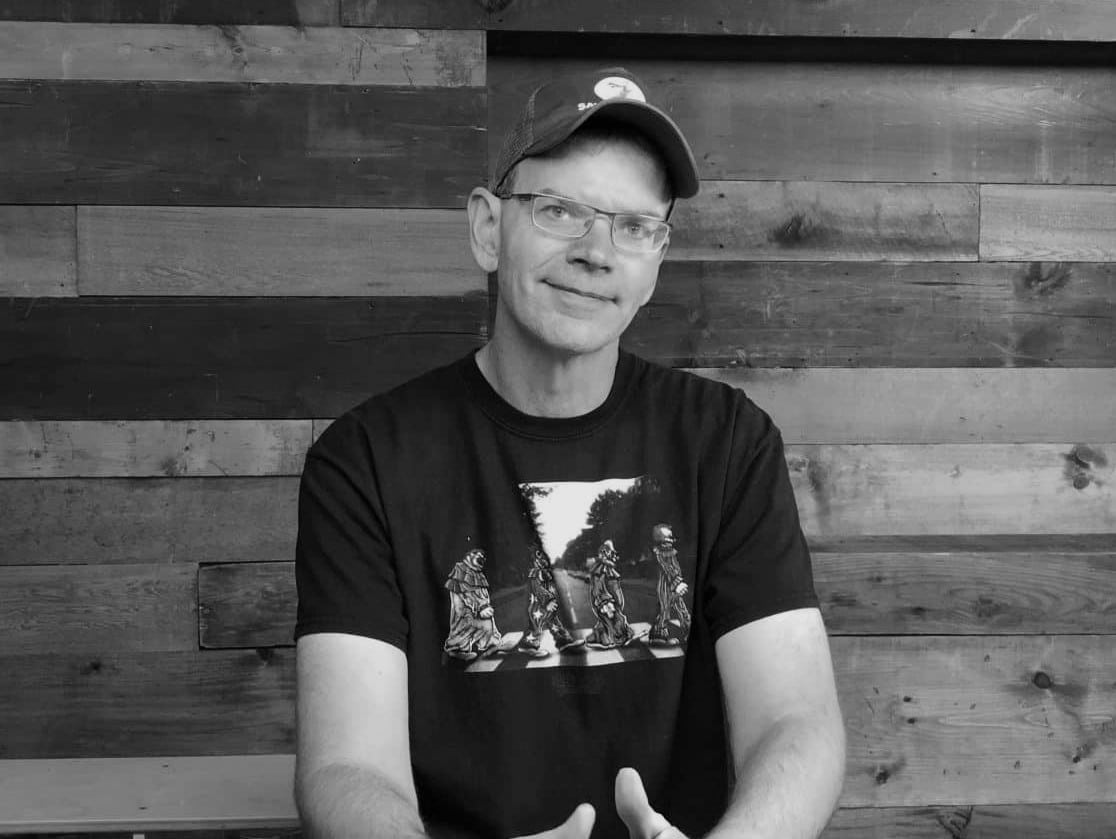 writer Jamie Nash, sitting and wearing a Save the Cat! cap