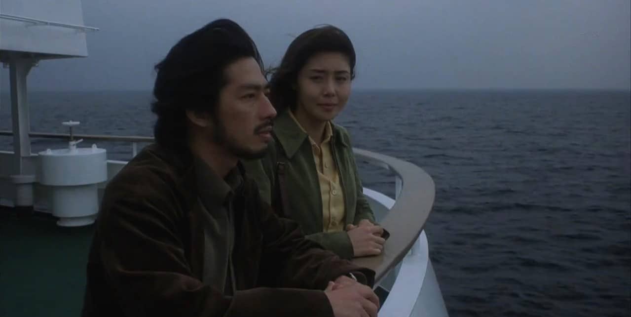 Asakawa and Ryūji on a boat, looking over the sea