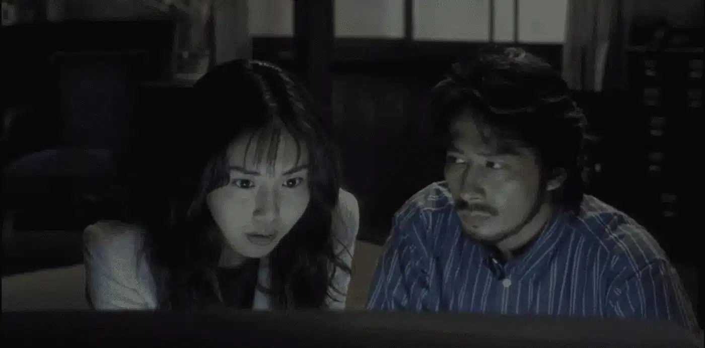 Askawa and her ex-husband stare into the television