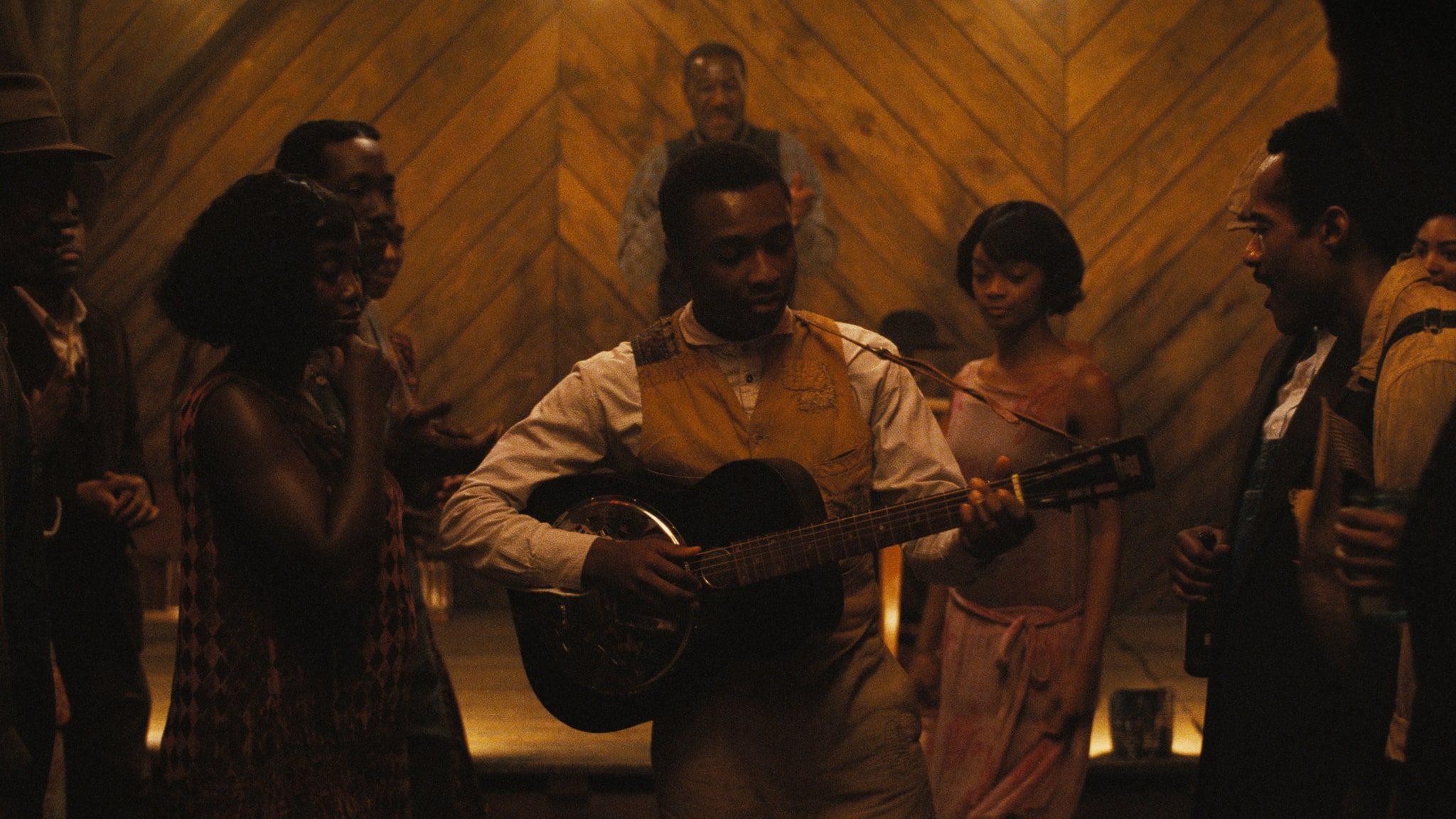 Preacher Boy playing his guitar as the crowd dances in Sinners