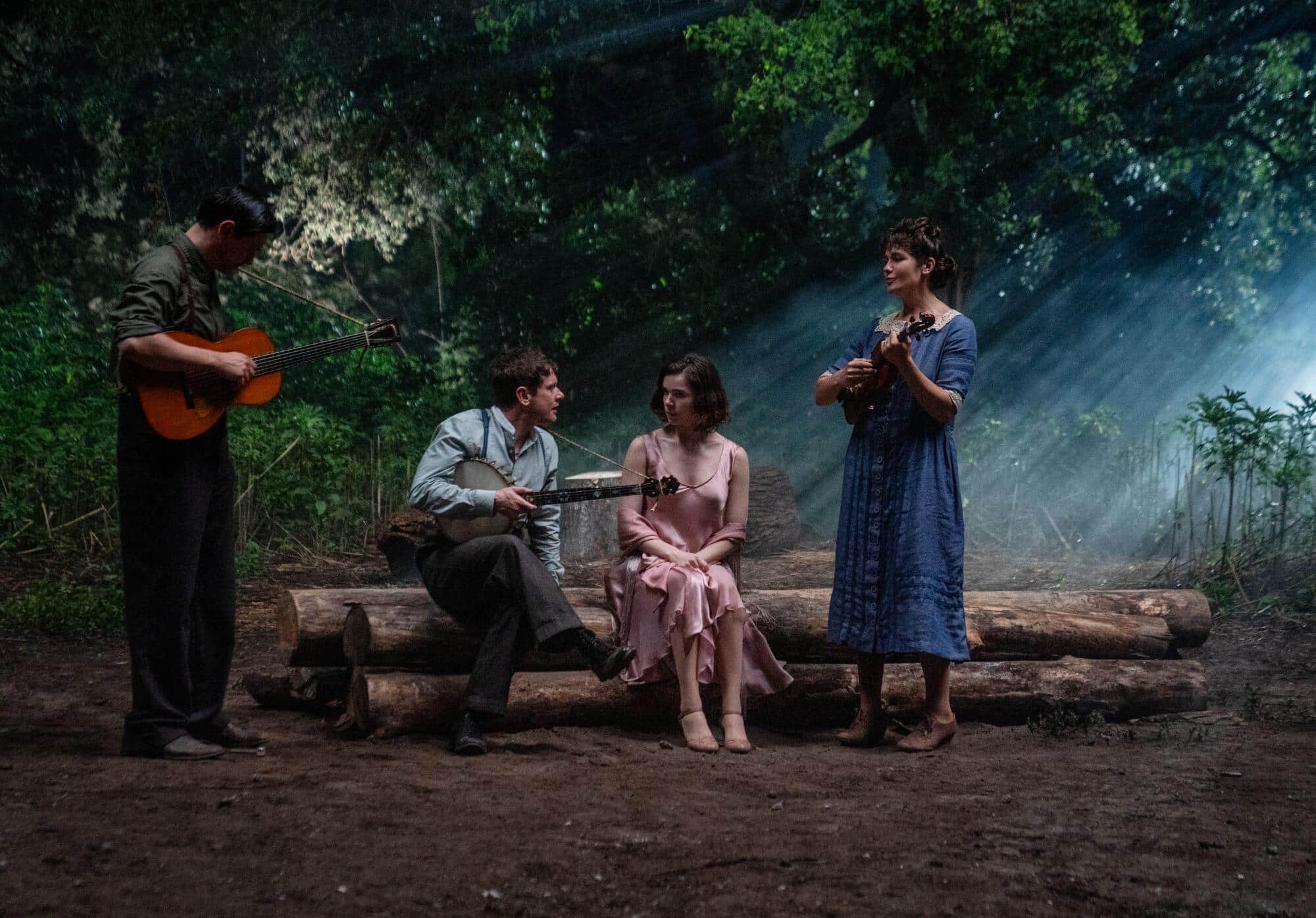 Outside on log benches, Remmick, Joan and Bert sing to Mary in Sinners