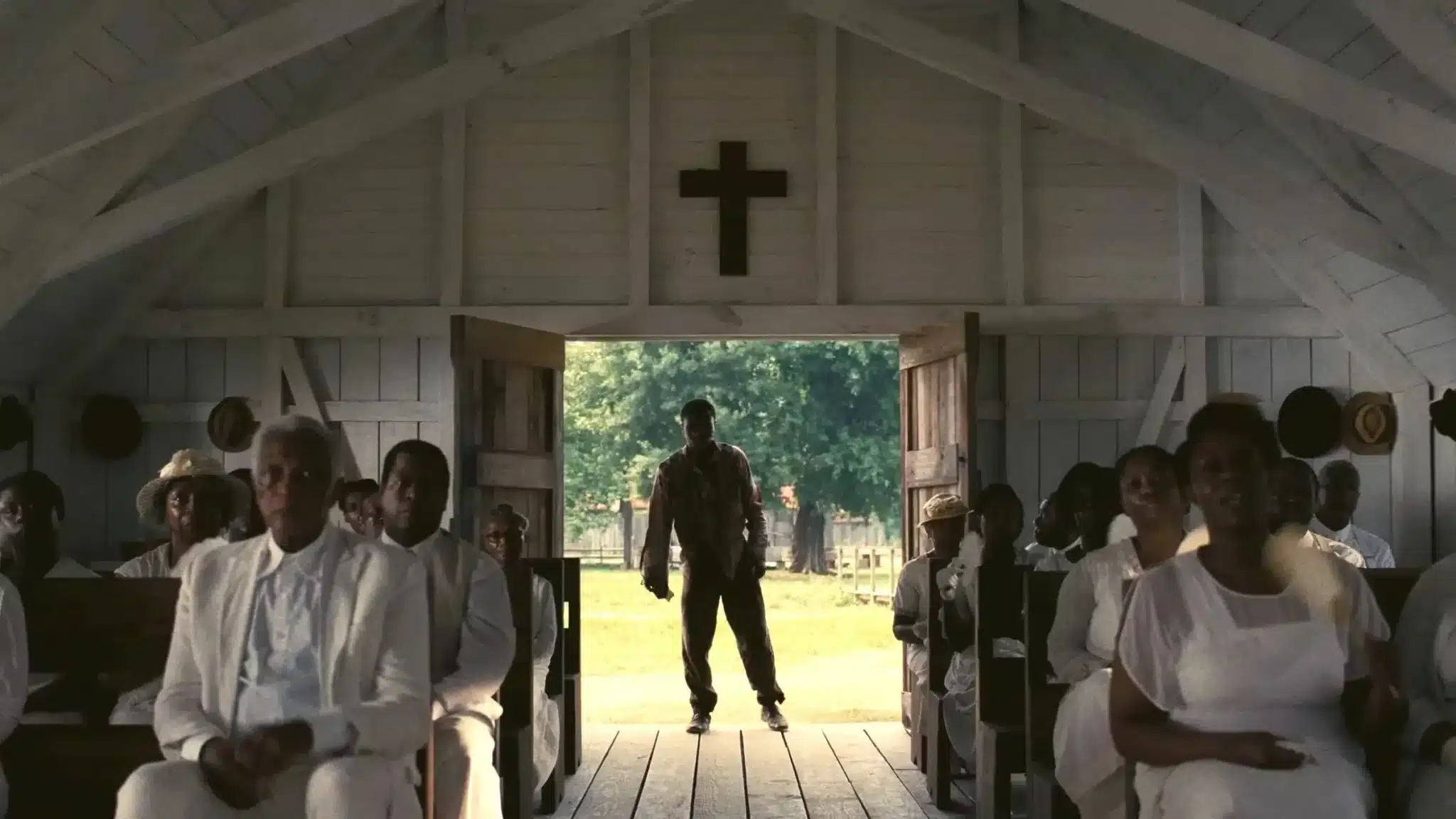 Sammie “Preacher Boy” Moore stands in the church door in the movie Sinners
