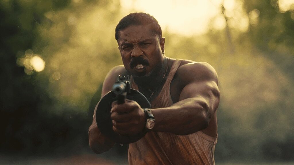Smoke firing his machine gun in Sinners