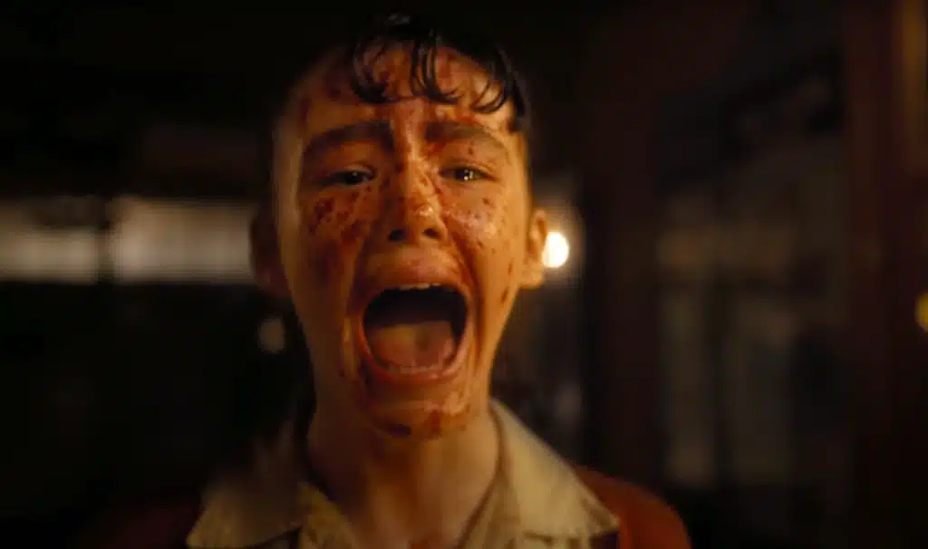 Blood smeared on her face, Lilly screams inside the theater in the pilot of IT: Welcome to Derry