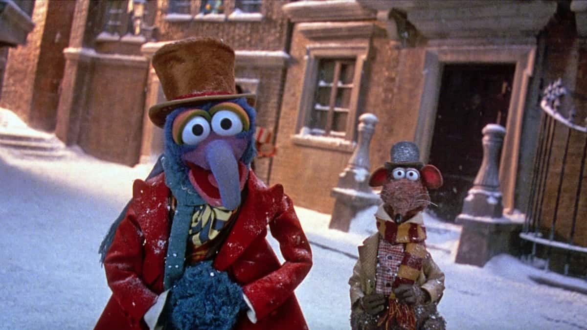 Gonzo and Rizzo the Rat on the snowy street of a Victorian town