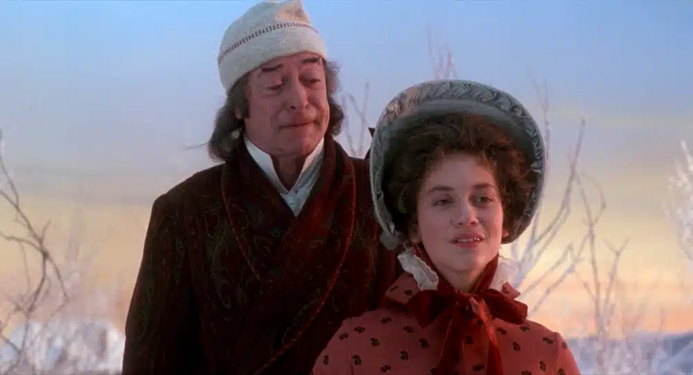 Michael Caine as Scrooge and Meredith Braun as Belle in an open field