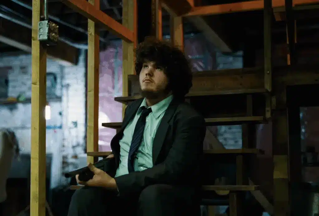 Don on the basement stairs, holding a shotgun