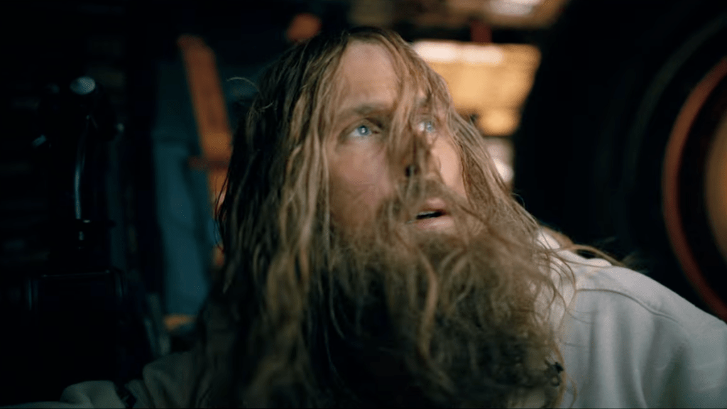 a bearded Ryan Gosling as Grace in a space capsule
