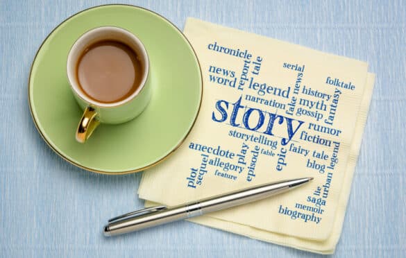 a coffee cup, pen, and a napkin with words including "story" on it