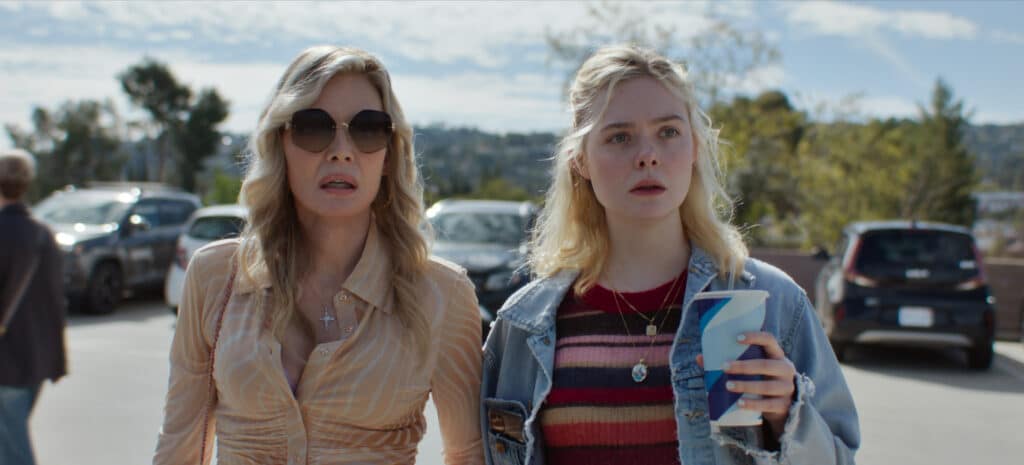 Michelle Pfeiffer and Ellen Fanning standing side by side in a parking lot