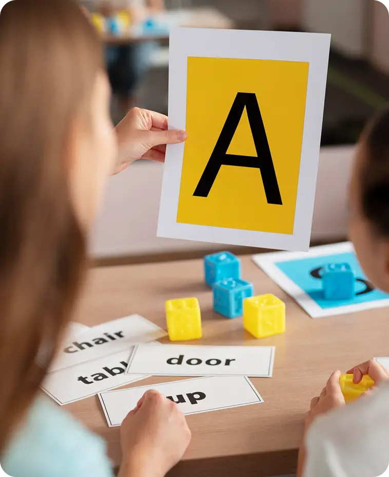Woman teaching child letters