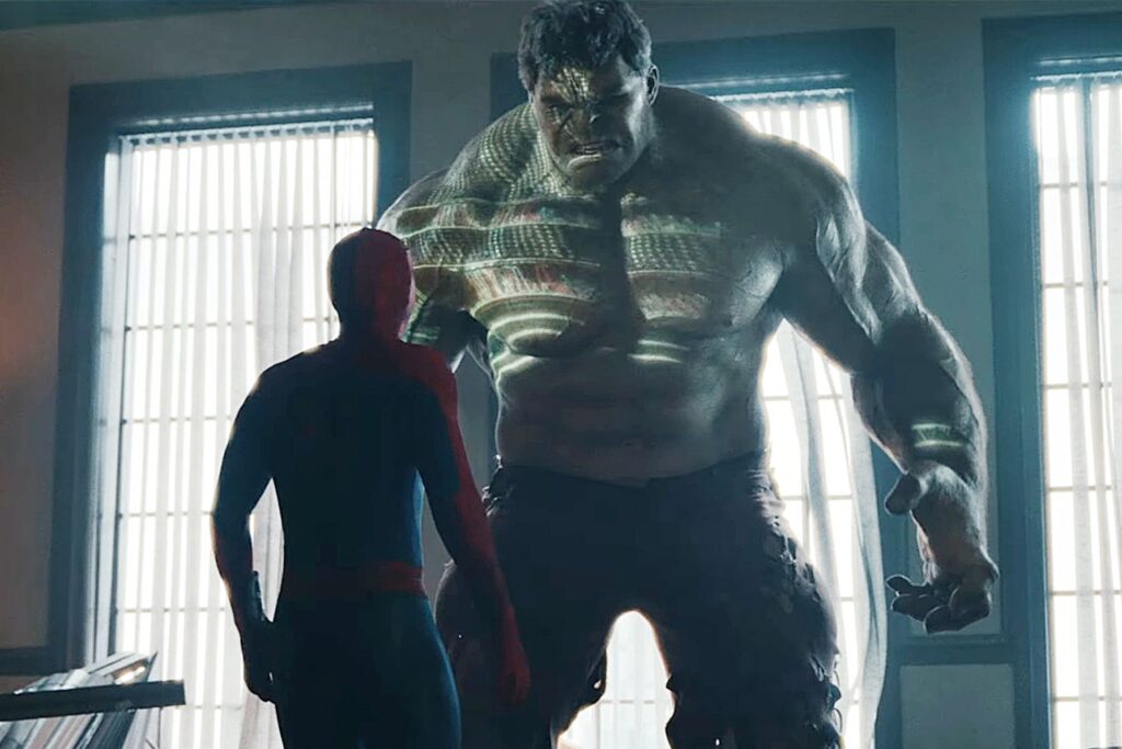 Spider-Man looks up at the massive Hulk.