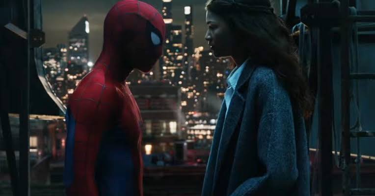 MJ and Spider-Man atop a building in the city