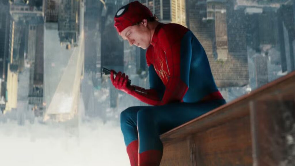 Spider-Man sits on the top of a building scrolling through his phone