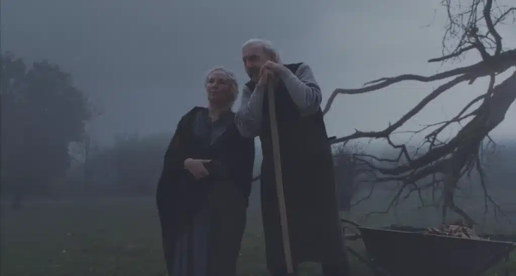 Bertha and Mr. Tuttle in the fog with a barren tree