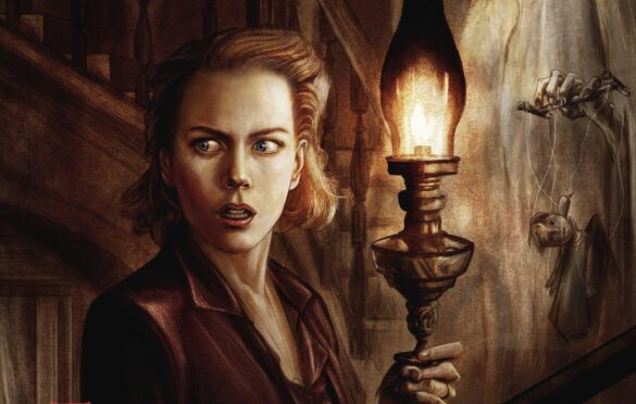 Nicole Kidman holding a torch in the movie The Others