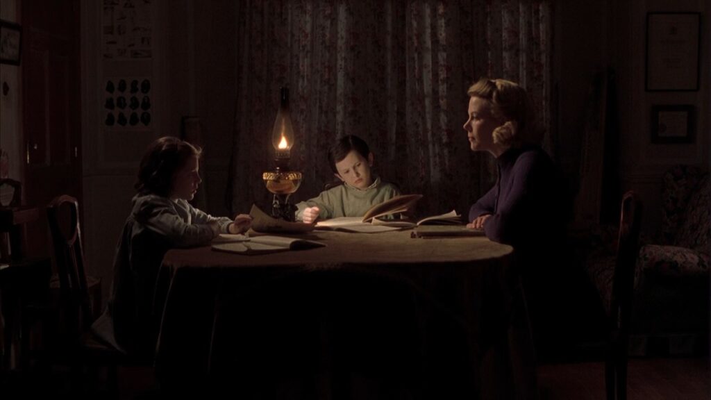 Grace sits with her 2 children at a table